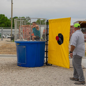 Man sitting in a dunk tank at an event