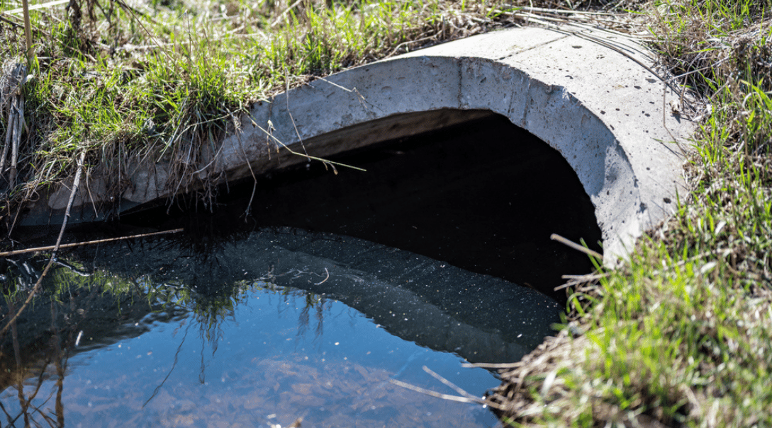 Contaminated stormwater runoff coming out of a concrete culvert