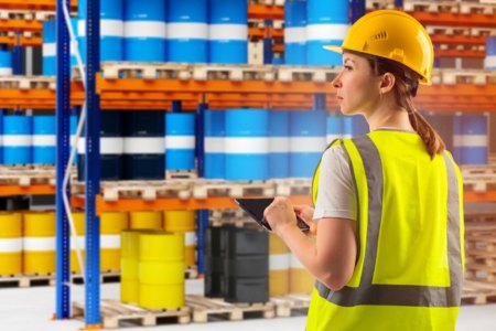 Environmental professional reviewing cans of waste after TCLP