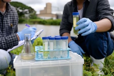 Team of people examining test tubes