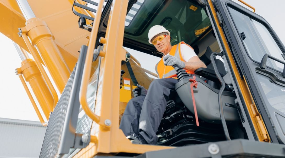 A worker operating a crane