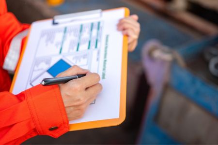 Worker reviewing waste checklist