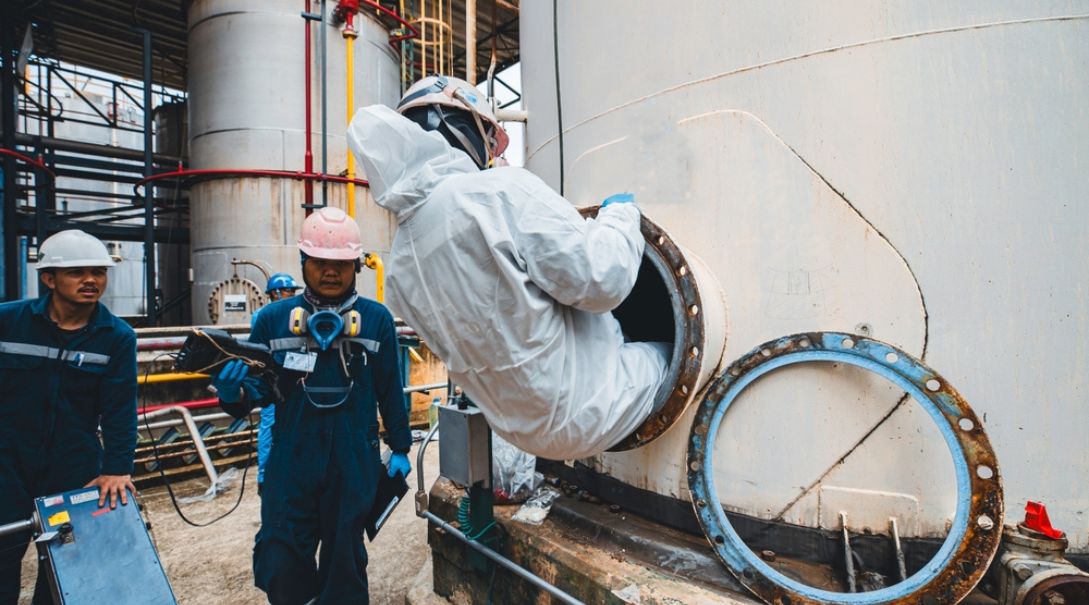 Worker entering confined space.