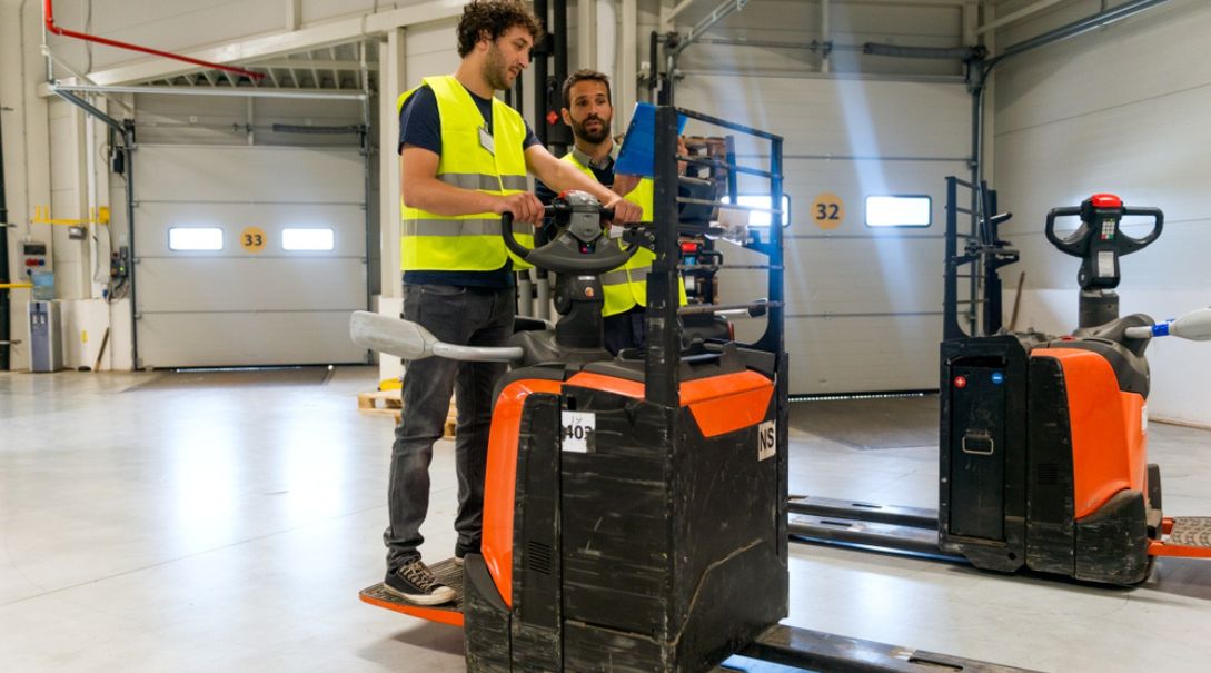 a man on a forklift being trained by an instructor for forklift safety