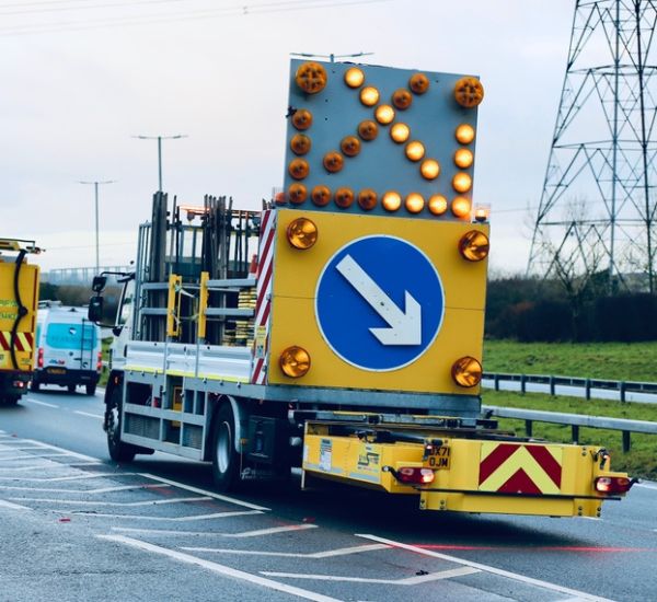 Traffic maintenance vehicle with directional signs