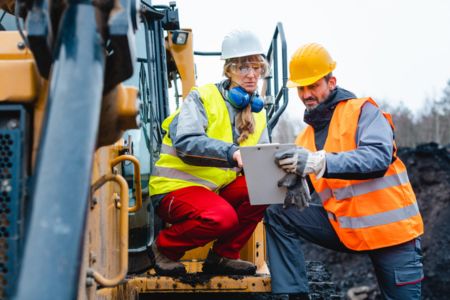 construction workers reviewing plans on site