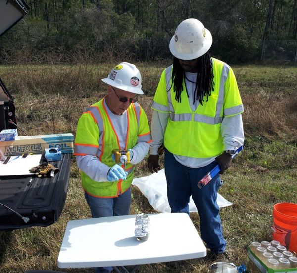 AOTC employees taking water samples
