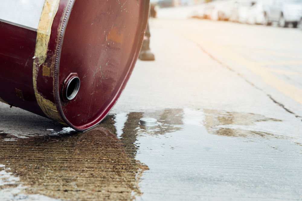 barrel leaking toxic chemicals onto pavement