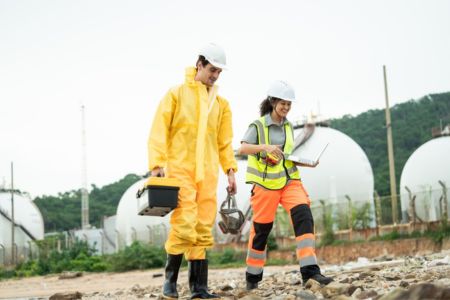 Workers Walking At A Industrial Facility Site.