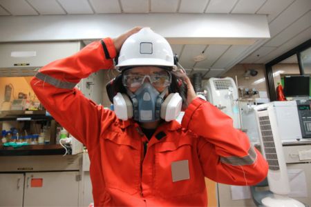 worker wearing respiratory protection during hazardous exposure evaluation