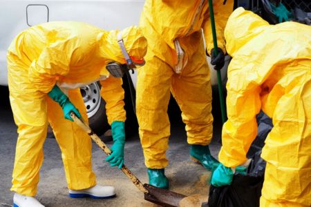 Worker Applying Absorbent for Chemical Spill Cleanup