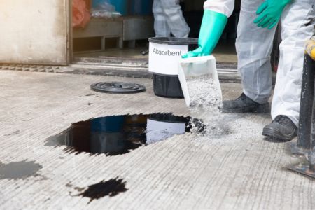 Workers Containing Chemical Spill in Industrial Workplace